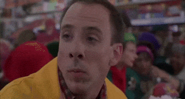Movie gif. A Scene from Jingle All the Way. A man in a business Christmas store bursts out in loud laughter. 
