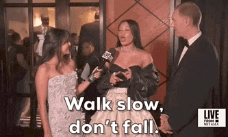 Met Gala 2024 gif. Storm Reid, speaking to a reporter, says "Walk slow, don't fall."