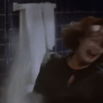 Movie gif. Faye Dunaway as Joan Crawford in "Mommie Dearest" cries and screams as she throws white cleaning powder around a bathroom.
