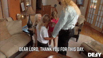 TV gif. Duane Chapman as Dog, the Bounty Hunter and his three young children hold hands in a circle and bow their heads in prayer. Text, "Dear lord, thank you for this day."