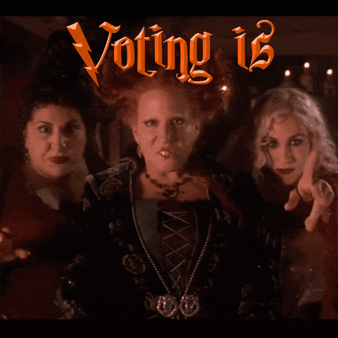 Disney gif. Bette Midler, Sarah Jessica Parker and Kathy Najimy as the Sanderson Sisters in Hocus Pocus, oogle and taunt and cast a spell. Text in orange lightning bolt font, "Voting is, magic."